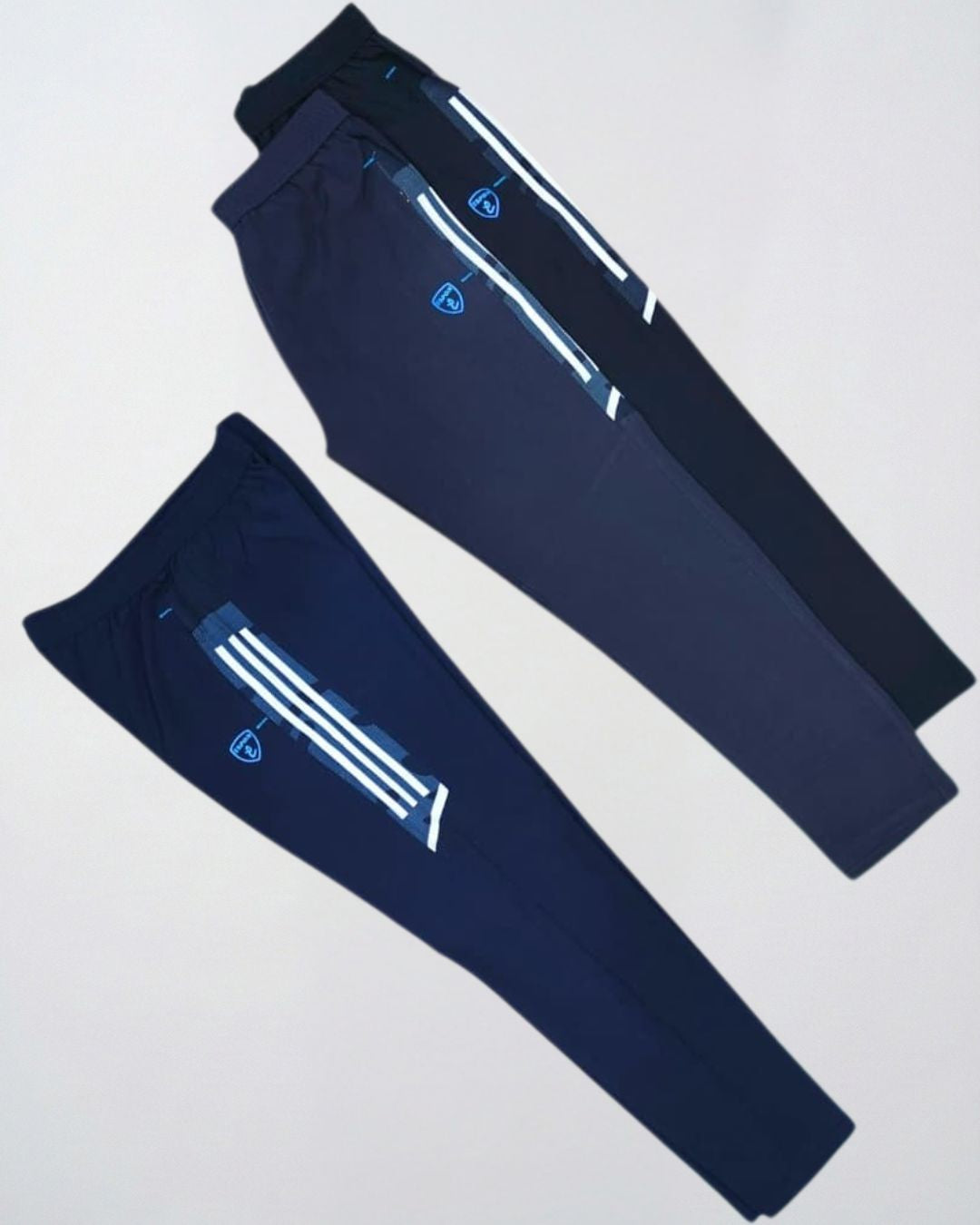 Two pairs of navy blue and black men's track pants with white stripe detailing, activewear