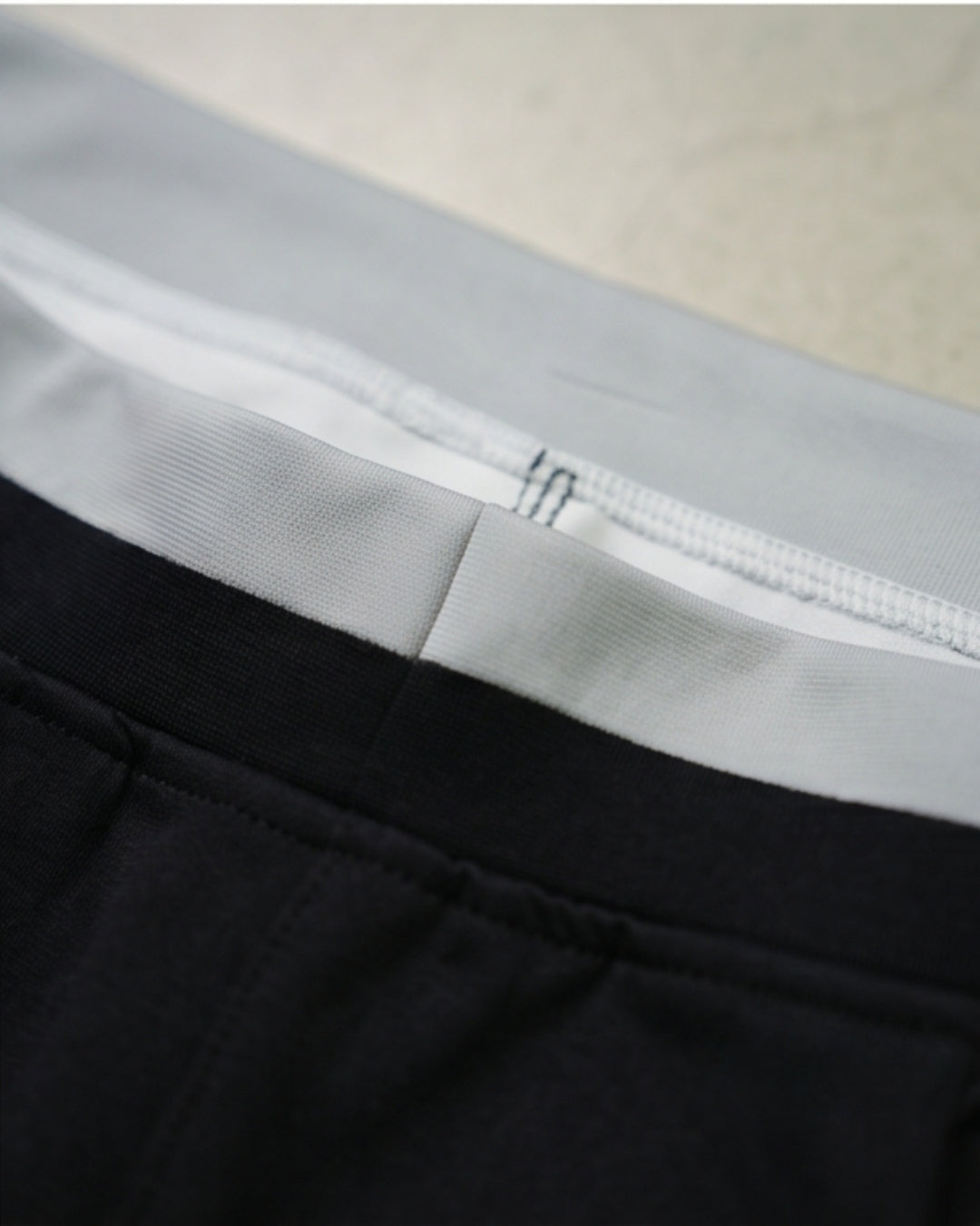 Close-up of premium track pants waistband with soft, durable fabric stitching